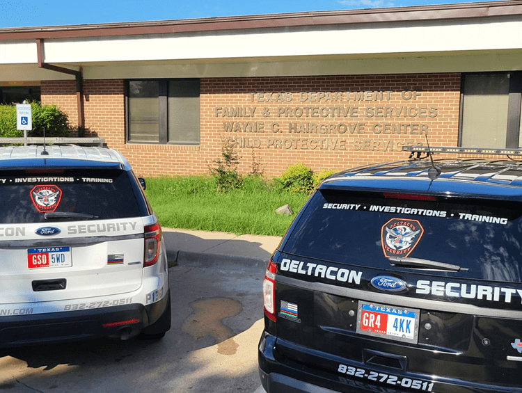 Two police cars parked in front of a building.