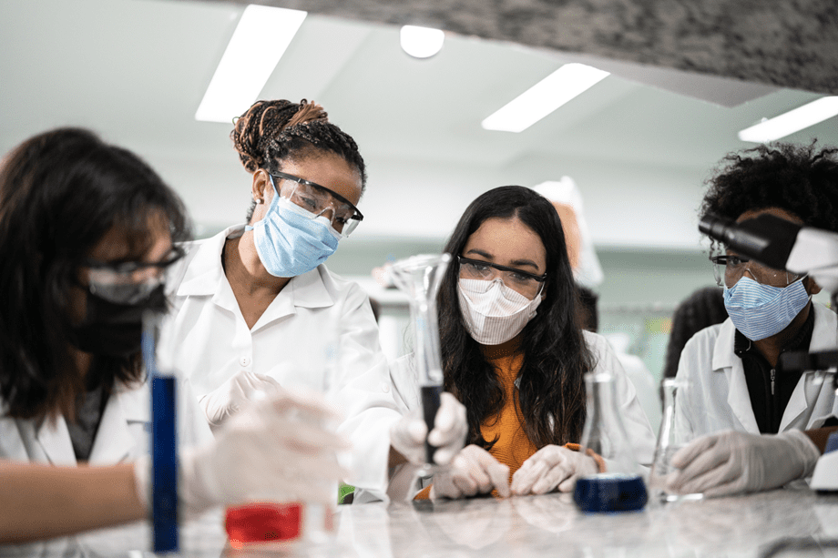 A group of people in lab coats and masks.