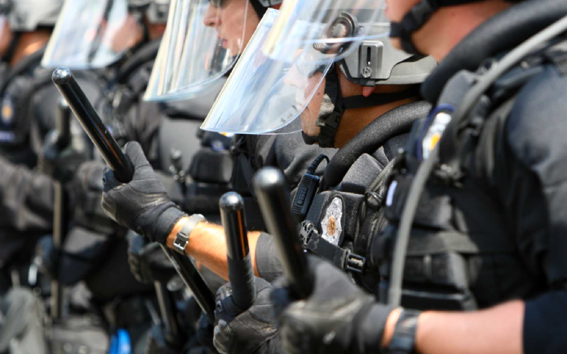 A group of people in police gear on a street.