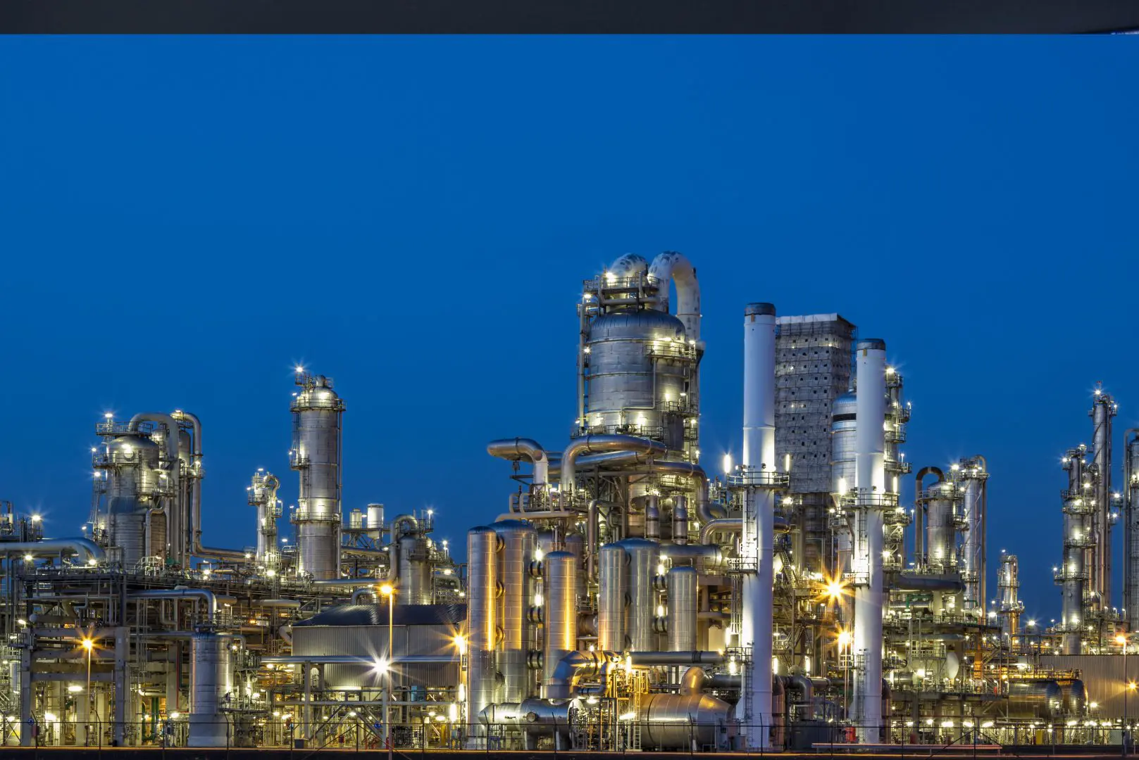 A large oil refinery with many pipes and towers.