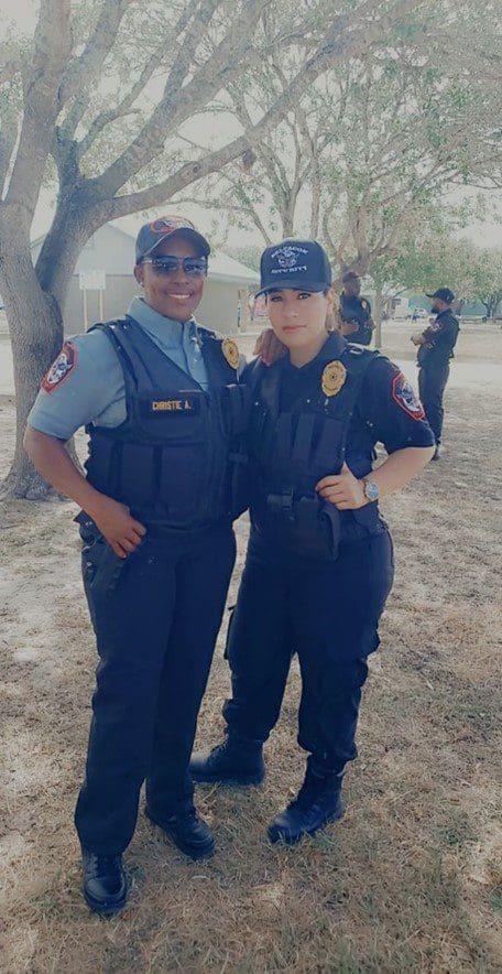 Two police officers standing next to each other.